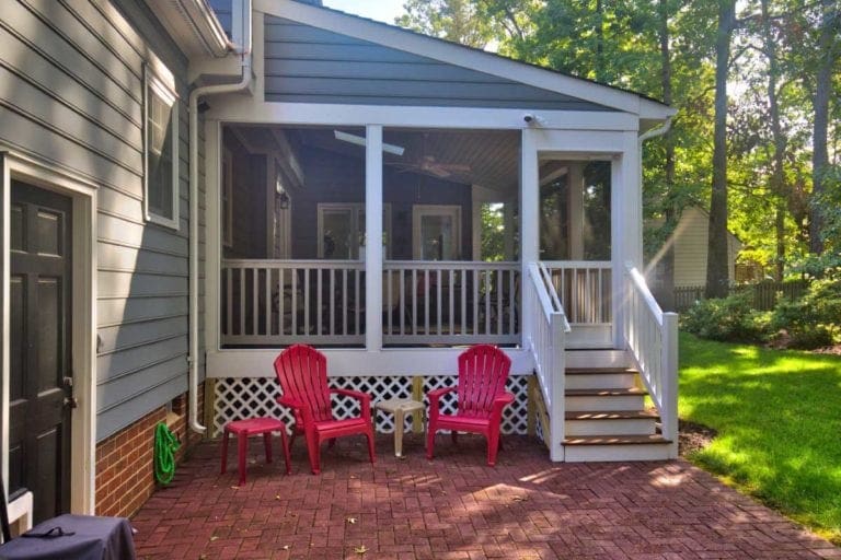 Screened Back Porch and Brick Patio with Outdoor Furniture Designed by Deck Creations.