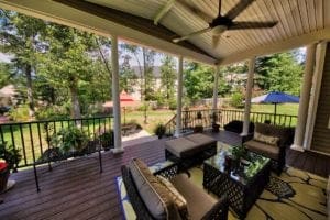 Large Wood Deck and Covered Porch Design with Outdoor Furniture by Deck Creations.