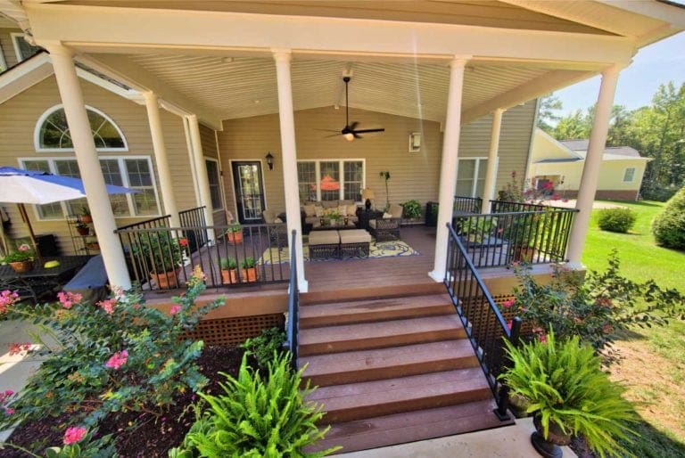 Gorgeous Deck with Outdoor Furniture and Tall Beams by Deck Creations.