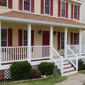 Long, Covered Front Porch with White Railing and Wooden Floors and Steps. Designed by Deck Creations.
