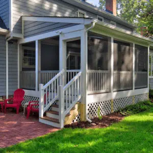 Screened Back Porch and Brick Patio with Outdoor Furniture Designed by Deck Creations.