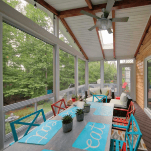 Outdoor covered patio space with raised ceilings and wood siding by Deck Creations.
