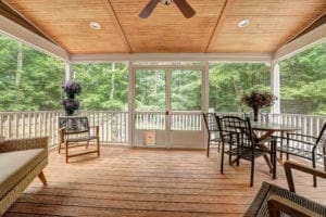 Inside view of a cute Covered Deck with an Outdoor Fan and Grill in Virginia. Designed by Deck Creations.
