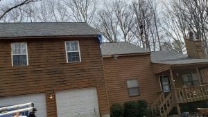 Before picture of a home with brown siding.