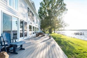 A breathtaking back deck designed and built by Deck Creations, offering stunning views of the water, backyard, and docks.