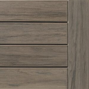 Close-up view of a weathered gray deck made from horizontal wooden planks.