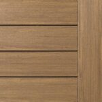 Close-up of wooden panels arranged horizontally with a vertical border on the right side, resembling a deck. The wood has a light brown color and visible grain texture.