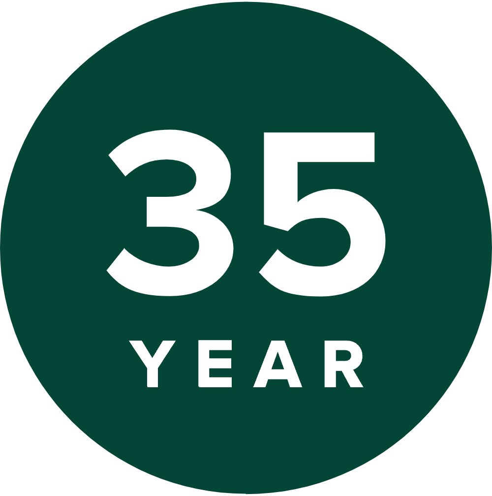 Green circle with white text displaying "35 YEAR," reminiscent of the timeless elegance you find in a well-crafted deck.