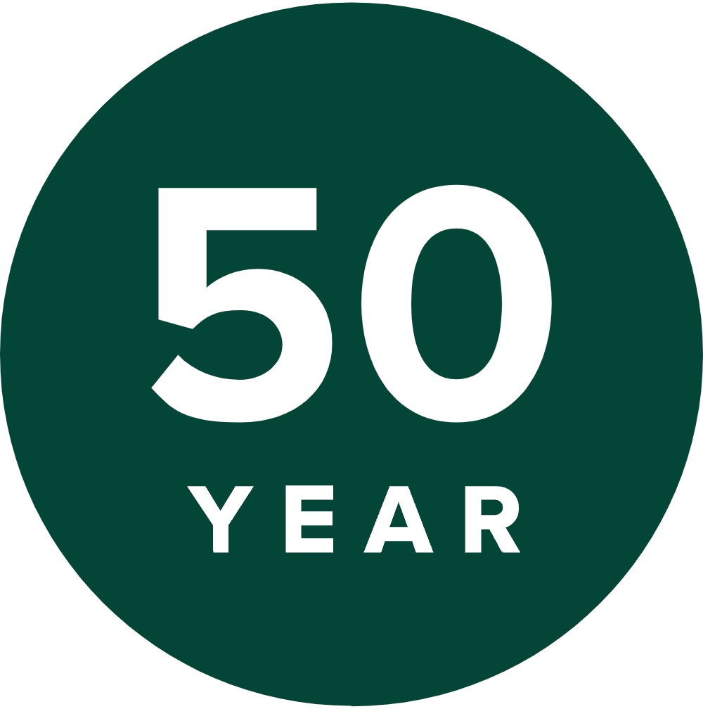 A dark green circle with the number "50" in large white letters and the word "YEAR" below, designed to look like a vintage deck marker.