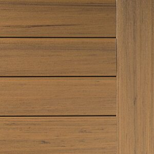 A close-up of a wooden deck panel reveals horizontal slats with a vertical border on the right. The light brown wood showcases subtle grain patterns, adding character and warmth.