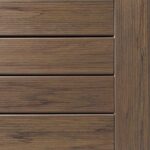 A close-up of deck planks arranged horizontally reveals a natural wood grain pattern in warm shades of brown.