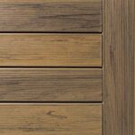 Close-up of a wooden deck panel with horizontal planks and visible grain patterns in a natural brown tone.