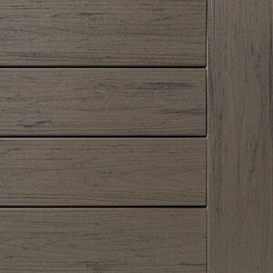 Close-up of a textured wooden deck panel with parallel grooves, showcasing its grayish-brown hue.
