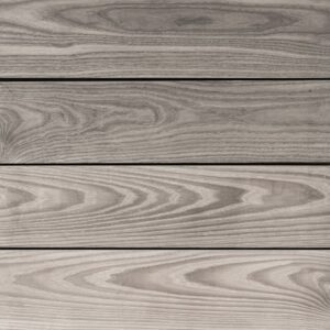 Close-up of deck with wooden planks showcasing a grayish tone and distinct wood grain patterns running horizontally.