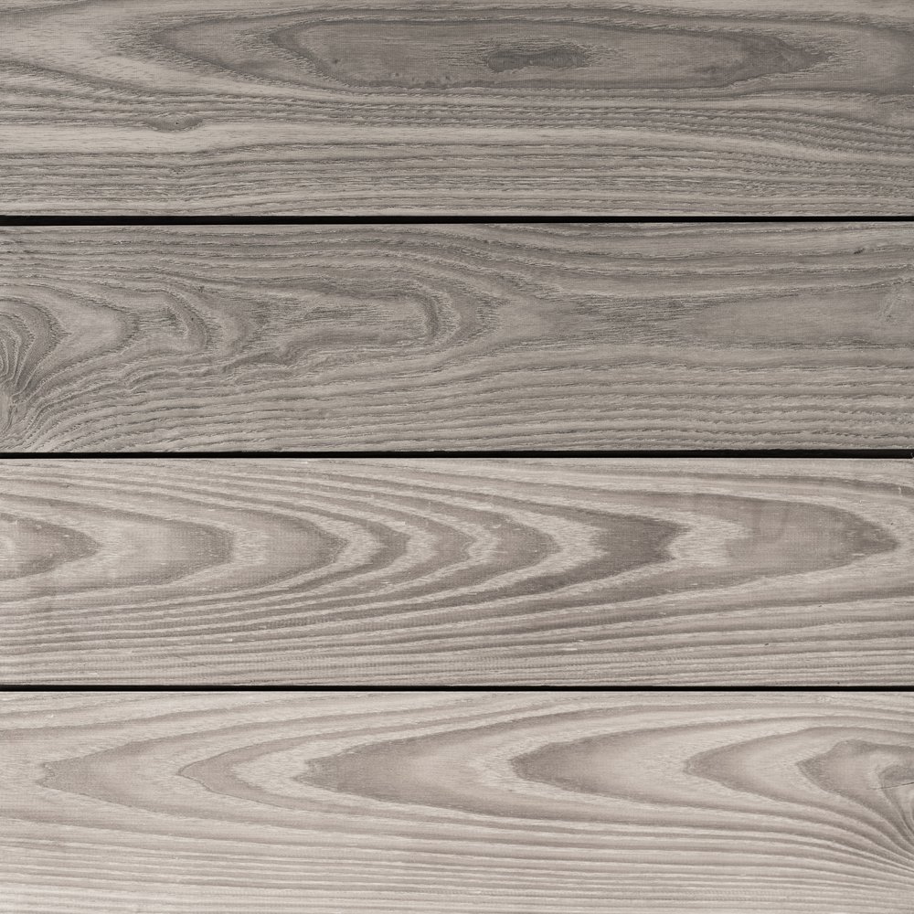 Close-up of deck with wooden planks showcasing a grayish tone and distinct wood grain patterns running horizontally.